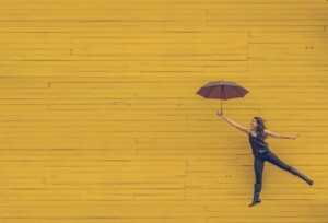 Mentally Healthy Woman Riding an Umbrella